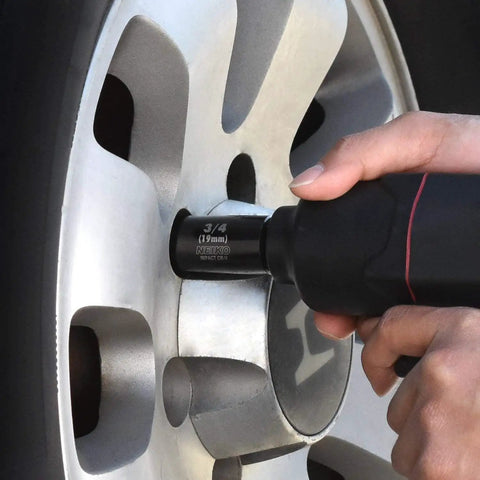 Using Master Impact Socket Set for Three Eighths Inch and One Half Inch Drives, 38 Piece, on car wheel lug nut with power tool