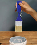 Two Inch Adjustable Angled Paint Brush Versatile Workhorse For Walls Acrylic And Oil Painting Flat Tip Craft Brush held above paint can