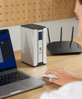 Compact 30000mAh Battery Backup Uninterruptible Power Supply With Surge Protector, USB Type C, DC Ports, LiFePO4 Power Bank on desk