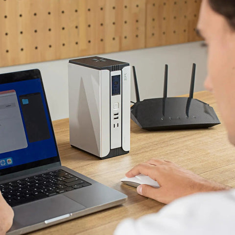 Compact 30000mAh Battery Backup Uninterruptible Power Supply With Surge Protector, USB Type C, DC Ports, LiFePO4 Power Bank on desk
