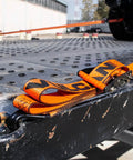Beefy Pro Series 2 Inch Ratchet Strap with Wire Hooks securing cargo on flatbed, optic orange webbing