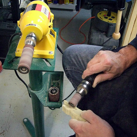 Person using Guinevere Basic Sanding Kit for Woodworking and Finishing on a lathe with rotary tool attachment