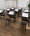 Premium Height Adjustable Tilting Drawing Desk With Tempered Glass Surface featuring multiple desks in an art studio.