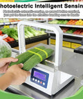 Automatic Tape Tying Machine With Foot Pedal Trigger And Optic Sensor For Produce Bagging dual mode used with cucumbers on packaging table.