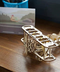 Mini Biplane 3D Puzzle Kit For Adults, Wooden Mechanical Model, DIY Craft Project, 3.15 Inch High, Hands-On Aviation Lover Gift, Classic Biplane Design, Challenging Build For Puzzle Fans And Flight Nerds on wooden desk