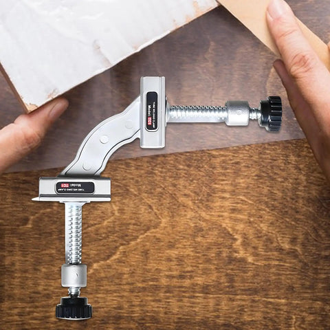 Heavy Duty Right Angle Welding Clamp With Precision Positioning Jig Forged From Cold Rolled Stainless Steel For Rock Solid 90 Degree Alignment in use with a hand adjusting the clamp.