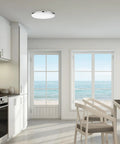 Ultra Slim 14 Inch LED Flush Mount Ceiling Light In Chrome With Frosted Shade illuminating a modern kitchen space.