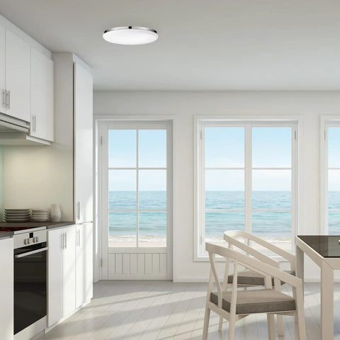 Ultra Slim 14 Inch LED Flush Mount Ceiling Light In Chrome With Frosted Shade illuminating a modern kitchen space.