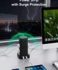 Heavy Duty Power Strip Tower Surge Protector With Sleek Low Profile Flat Plug Cord And 12 Spacious AC Outlets Plus 4 Dual Charge USB And Type C Ports Making Your Daily Desk Setup Sick And Seamless For Dorms Black placed on a desk with devices.