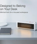 Graphene Far Infrared Mini Desk Heater for Personal Office Use on desk next to notebook and lamp, showing compact design.