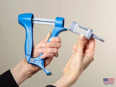 Hands holding a Drywall Repair Kit With Built In Spatula Tool And Two 20ml Spackling Paste Cartridges To Fill Nail Holes And Cracks.