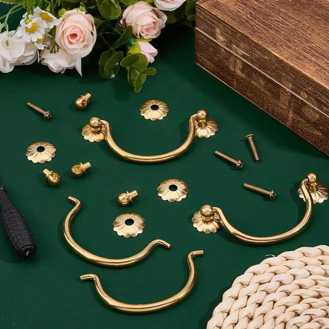 Six Pack Traditional Bail Cabinet Hardware In Vintage Gold With Old School Vibe 80mm Center Hole Pulls detailed on green background