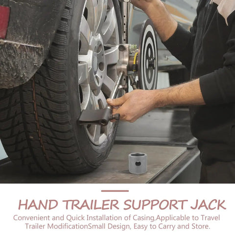 Person adjusting hand trailer support jack on vehicle tire