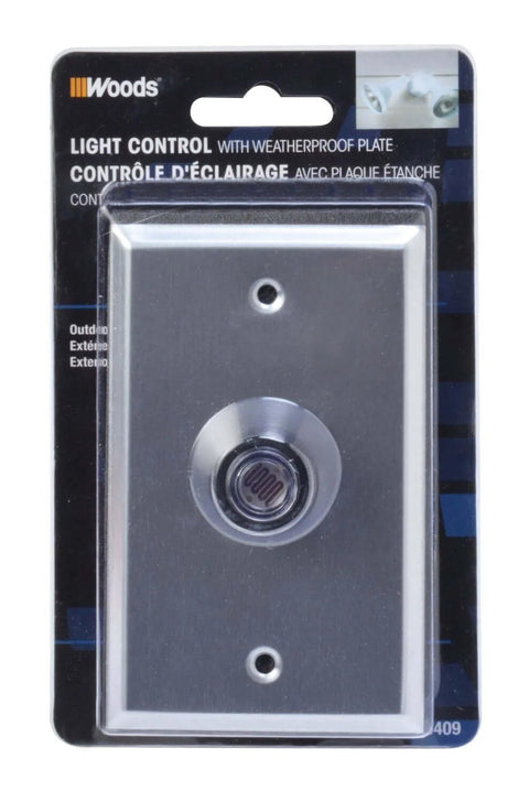 Outdoor Hardwired Post Eye Light Controller And Wall Plate With Dusk To Dawn Sensor in metallic silver packaging.