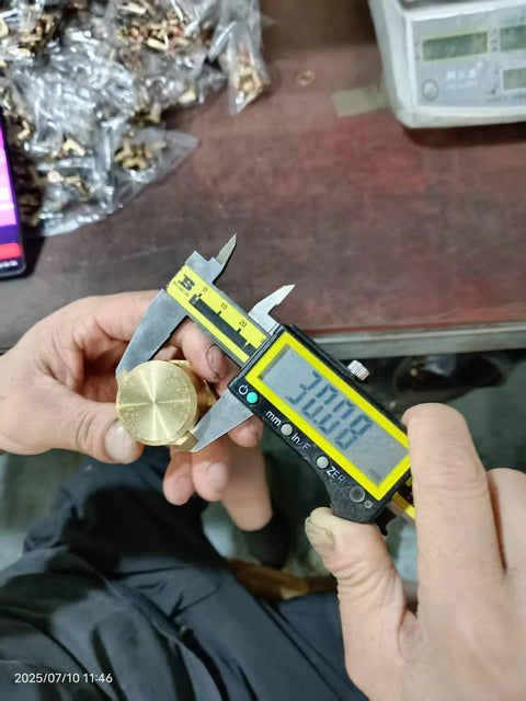 Brass 3/4 in NPT female pipe cap with hex head, being measured with calipers