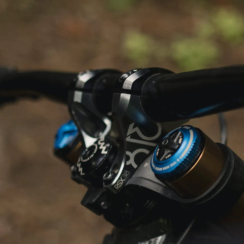 Close-up of RSX Direct Mount Mountain Bike Stem for 31.8mm bars, lightweight split design on dual crown forks, adjustable extension.