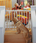 Adjustable Wooden Baby Gate For Stairs From 28 To 42 Inches Wide And 30 Inches Tall, child and dog behind gate on stairs