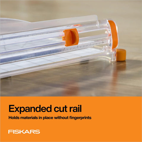 Precision Paper Trimmer With SureCut Wire Cut Line And TripleTrack System showing expanded cut rail on wooden surface.
