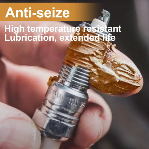 Applying copper anti-seize lubricant for high-temp automotive use on spark plug for preventing corrosion and easy disassembly.