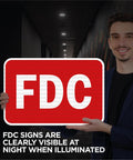 Built Like A Tank Fdc Fire Department Connection Sign 12 By 18 Inches held by a person in a hallway, visible in dim lighting.