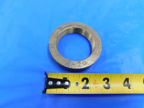Top Shelf 2 Inch 20 Thread Brass Ring Gauge Nut Spacer For Precision Calibration And Machine Shop Work Built Sick Tight With Smooth Finishes For Heavy Duty Tasks Real Deal Engineering MH3938LVR with ruler on blue background.