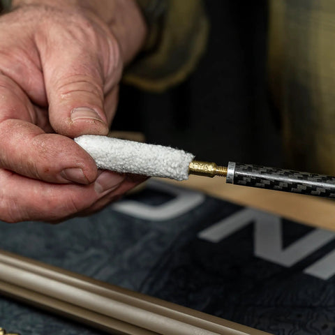 Close-up of hands using Caliber 50 Muzzleloader Cleaning Kit With Caliber Specific Bronze Bore Brush Pierce Point Jag Slotted Tip 100 Percent Cotton Patches Nylon All Purpose Cleaning Brush Straight Pick And Hand Tool Go To Gear For Your Muzzleloader Maintenance.