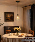 7.5 Black Hammered Glass Pendant Lights Kitchen Island Lighting 1 Pack E26 hanging above a dining table with flowers.