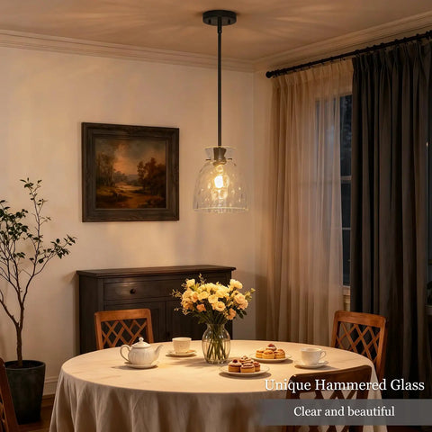 7.5 Black Hammered Glass Pendant Lights Kitchen Island Lighting 1 Pack E26 hanging above a dining table with flowers.