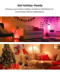 Living room decorated for holidays with dim lighting and festive decor like banners, bats, Christmas tree with lights and gifts.