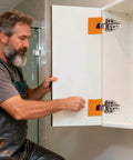 Man using Cabinet Door Mounting Jig With Magnetic Locking For No Drill Installation And Quick Cabinet Hinge Alignment on cabinet