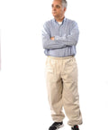 Man wearing beekeeping pants for full lower body protection from bees and wasps, heavy duty workwear with reinforced knees.