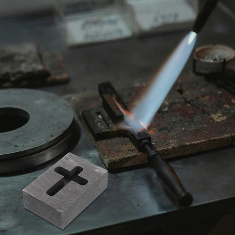 Graphite Cross Shaped Casting Mold for Melting Trusted by Jewelers High Precision Graphite Tool on metalwork table with torch