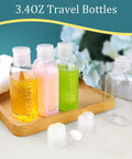 Leakproof Travel Bottles 4 Pack 3.4 Oz TSA Approved Squeeze Containers for Shampoo, Conditioner, and Body Soap on wooden tray.