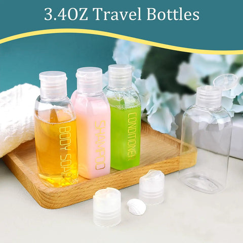 Leakproof Travel Bottles 4 Pack 3.4 Oz TSA Approved Squeeze Containers for Shampoo, Conditioner, and Body Soap on wooden tray.