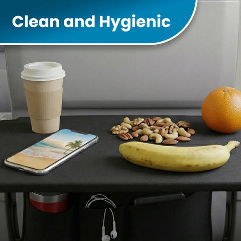 Air Travel Tray Cover And Seat Back Organizer For Flights with snacks, phone, and cup on black tray in airplane