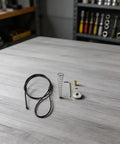 Black Spring-Loaded Gate Latch Cable Pull for Garden Wood Vinyl Fence components including cable, spring, and screws on a workspace.