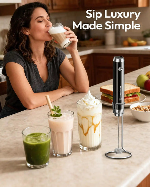 Kitchen scene with woman enjoying drink next to LunaFro Handheld Milk Frother With Stand, Rechargeable, Waterproof Stainless Steel Whisk.