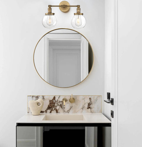 Industrial Style Double Wall Sconce Light, Hardwired, 5.9 Inch Round Clear Glass Shade, in modern bathroom decor above round mirror