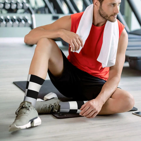 Top Shelf Black And White Piano Plate Grid Athletic Socks Engineered For The Daily Grind on a man in gym setting.