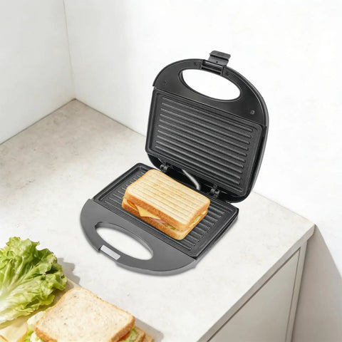 This Sweet 900 Watt Electric Sandwich Maker And Steak Grill Is A Total Game Changer For Your Kitchen Or Office Setup, featuring a sandwich placed inside.
