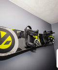 Heavy Duty Snowboard Wall Mount Rack For Garage Organization And Wall Storage holding a snowboard on a gray wall