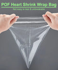Hands holding a clear POF heart shrink wrap bag, showcasing its durability and flexibility for packaging.