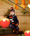Child holding Strawberry Paper Lanterns Set Of 4 Large 8 Inch And 12 Inch Hanging Decor 3D Red Strawberry Party Lanterns on steps
