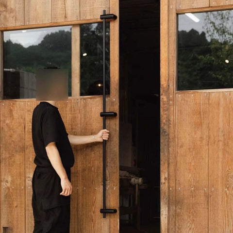 Person opening wooden door with Stainless Steel Push Pull Door Handles For Exterior And Interior Doors With Tough As Nails Heavy Duty Non Rust Construction Easy Install Kit Included With All Hardware Drill Two Holes And Secure With Two Screws Durable Modern Entry Pulls installed