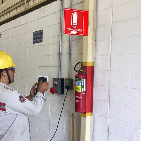 Two Pack 6x6 Acrylic Fire Extinguisher Sign With Down Arrow, UV Protected And Fade Resistant, installed in indoor setting next to extinguisher.