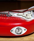 Killer Electric Guitar Output Jack Plate With Quarter Inch Connector and Two Mounting Screws on red guitar body