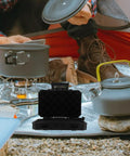Black Tactical Outdoor Storage Box With Modular Attachment System under camping setup
