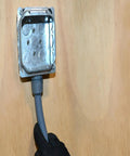Three Quarter Inch Liquid Tight Flexible Non Metallic Conduit For Direct Burial, connected to metal box by gloved hand
