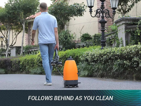 Man walking with Beast Cordless Portable Pressure Washer With 22L Tank And 12000mAh Battery on stone path