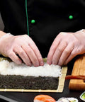 Hands using Straight Up Premium Clear Vinyl Exam Gloves Large 1000 Pack Latex Free Powder Free to prepare sushi rice.